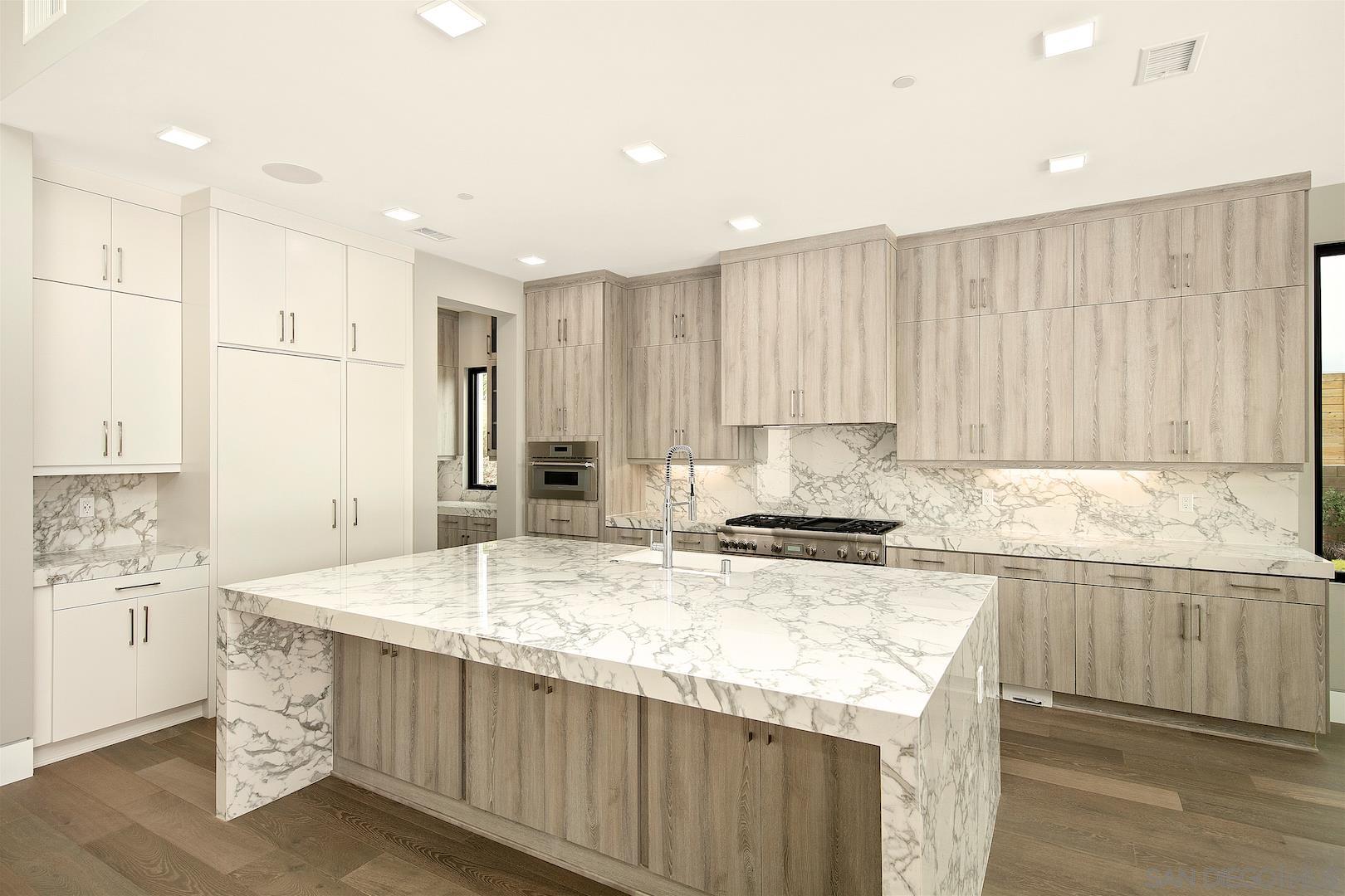 1817 Gwynn Drive Cardiff, CA 92007 - Photo 15 of 50 a kitchen with kitchen island granite countertop a stove and a sink