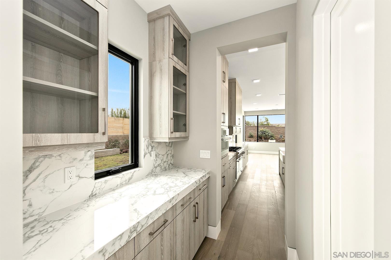 1817 Gwynn Drive Cardiff, CA 92007 - Photo 17 of 50 a bathroom with a granite countertop sink a bathtub and shower