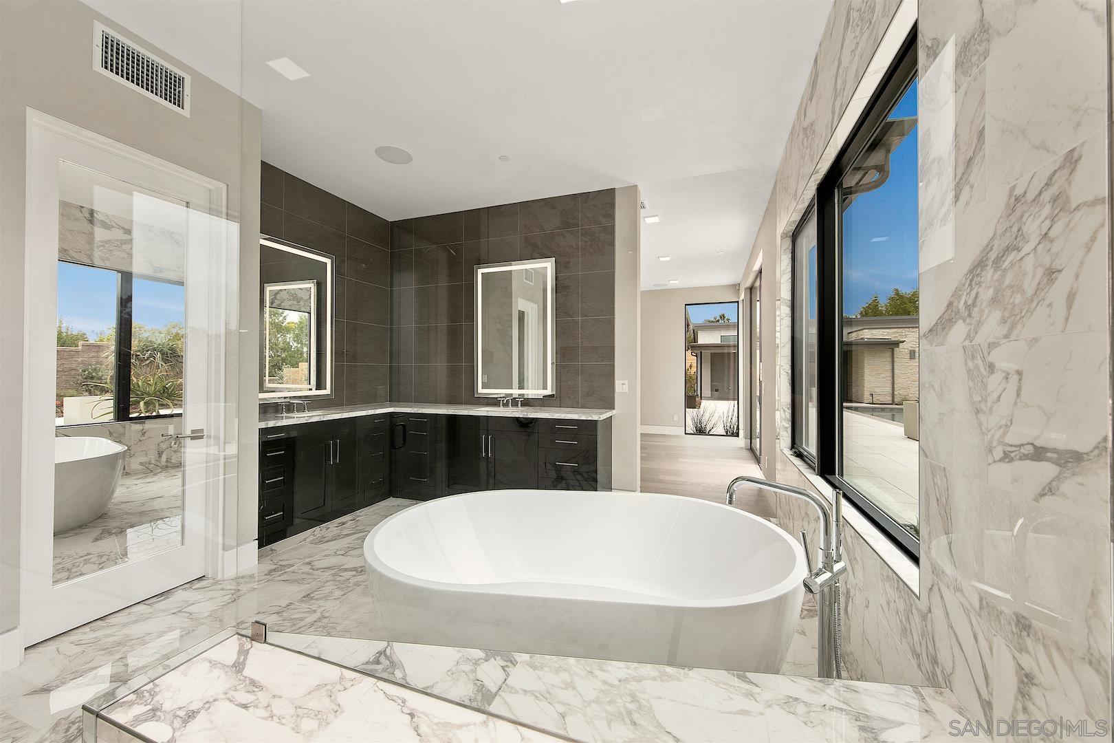 1817 Gwynn Drive Cardiff, CA 92007 - Photo 35 of 50 a bathroom with a granite countertop tub sink and mirror
