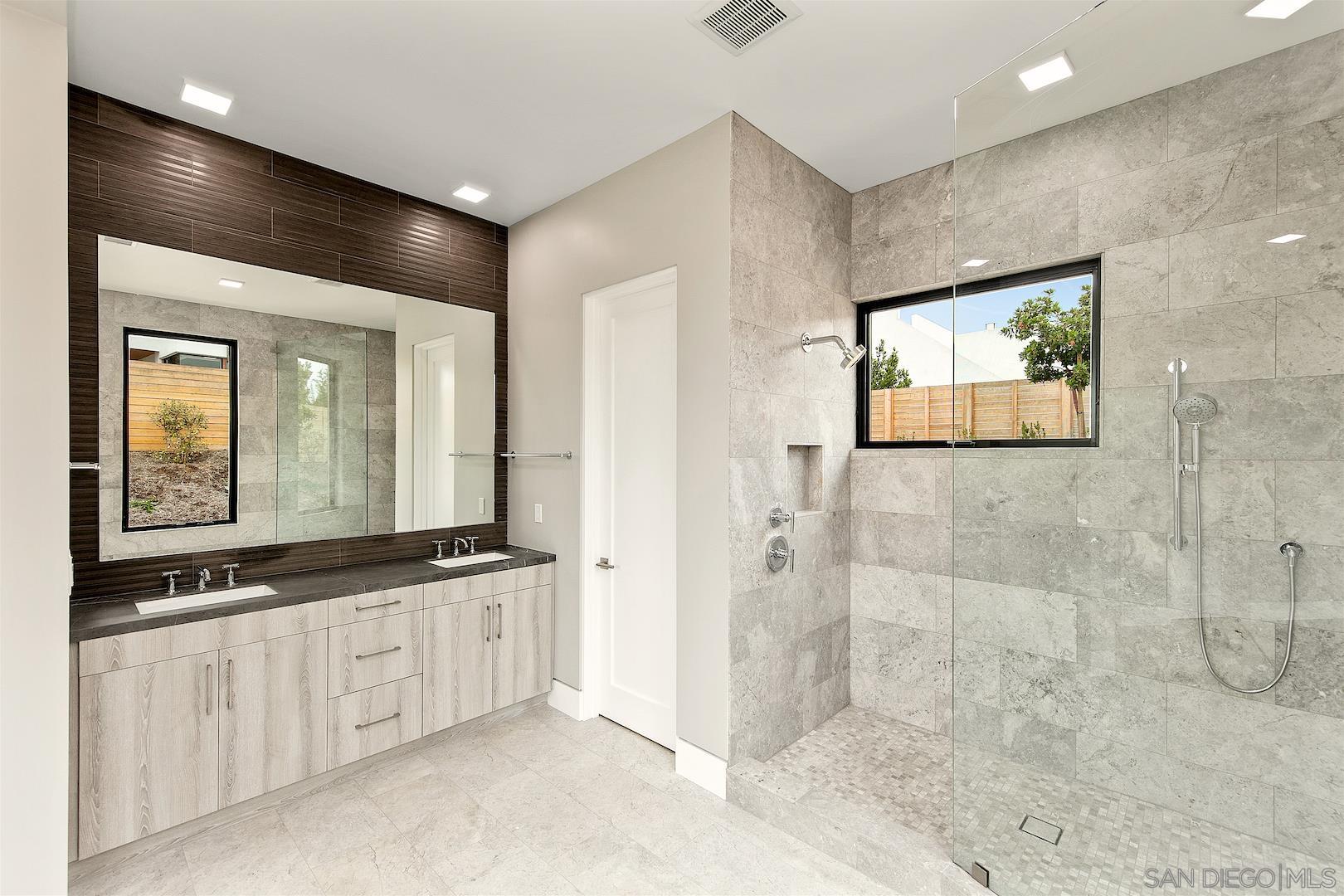 1817 Gwynn Drive Cardiff, CA 92007 - Photo 40 of 50 a bathroom with a double vanity sink and mirror