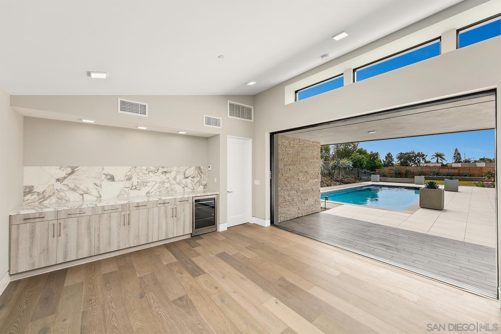 1817 Gwynn Drive Cardiff, CA 92007 - Photo 46 of 50 a view of a kitchen with kitchen island a sink wooden floor and window