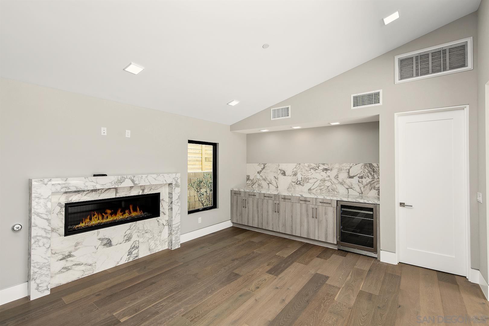 1817 Gwynn Drive Cardiff, CA 92007 - Photo 48 of 50 a living room with stainless steel appliances furniture a fireplace and a kitchen view