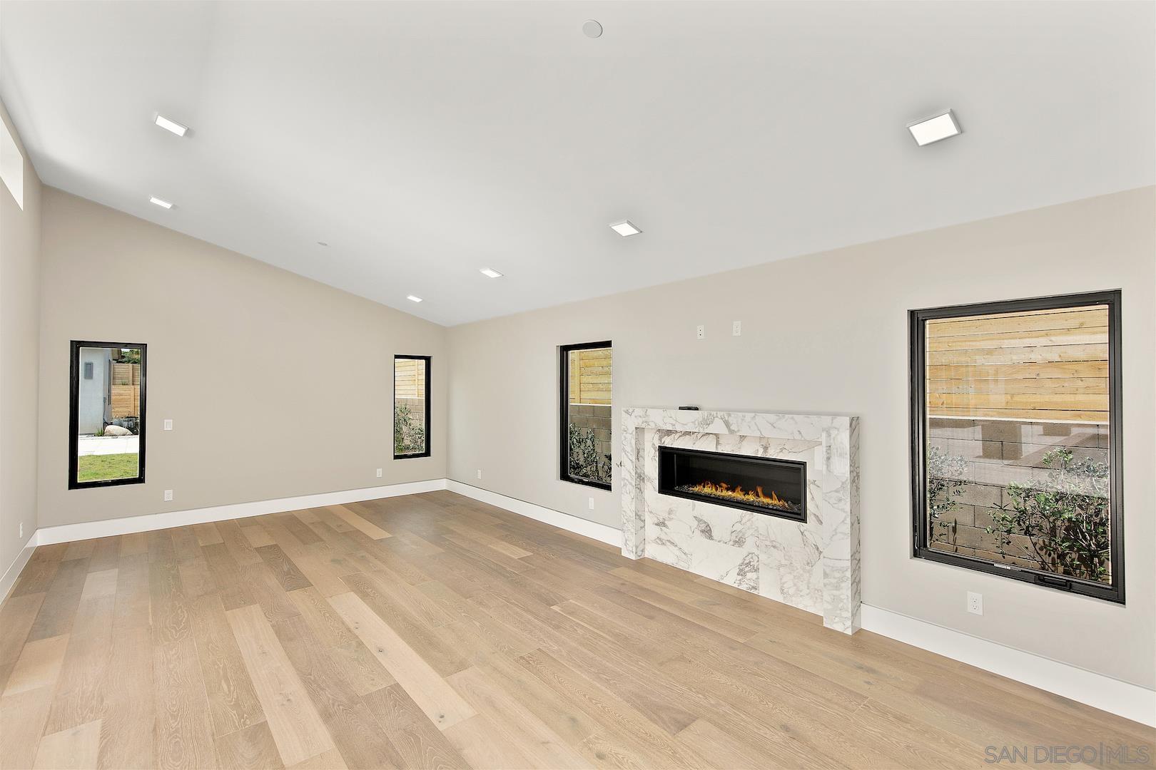 1817 Gwynn Drive Cardiff, CA 92007 - Photo 49 of 50 an empty room with windows and fireplace