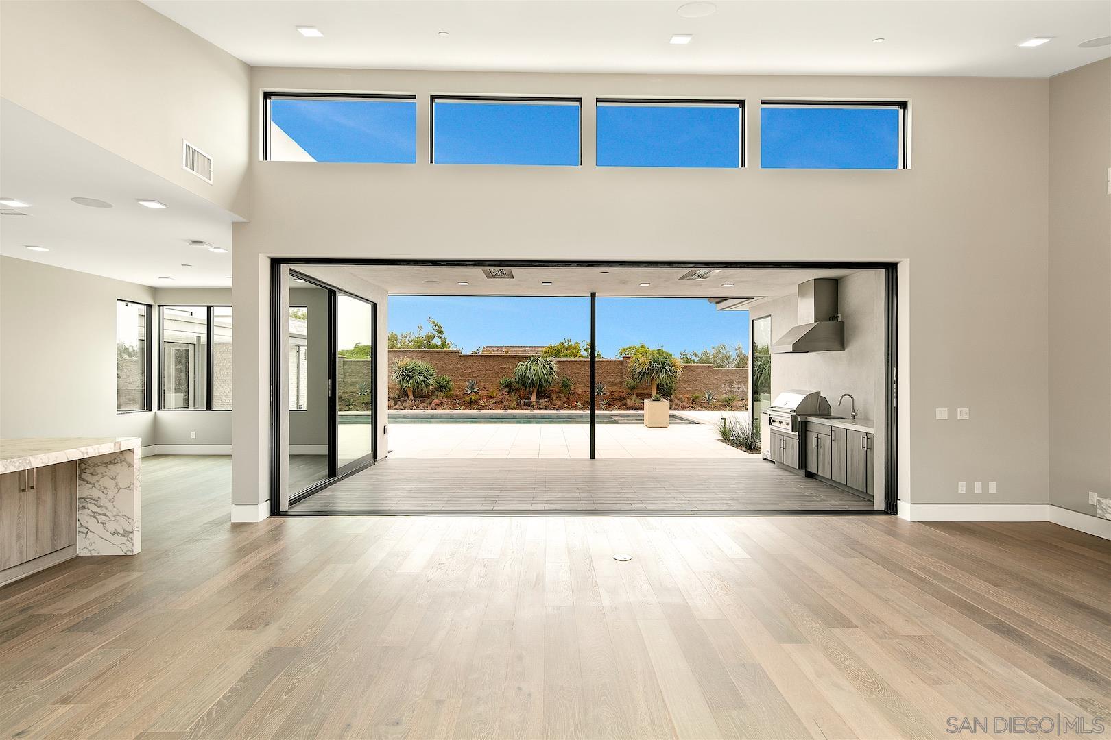 1817 Gwynn Drive Cardiff, CA 92007 - Photo 10 of 50 a view of a hallway with wooden floor and a fireplace