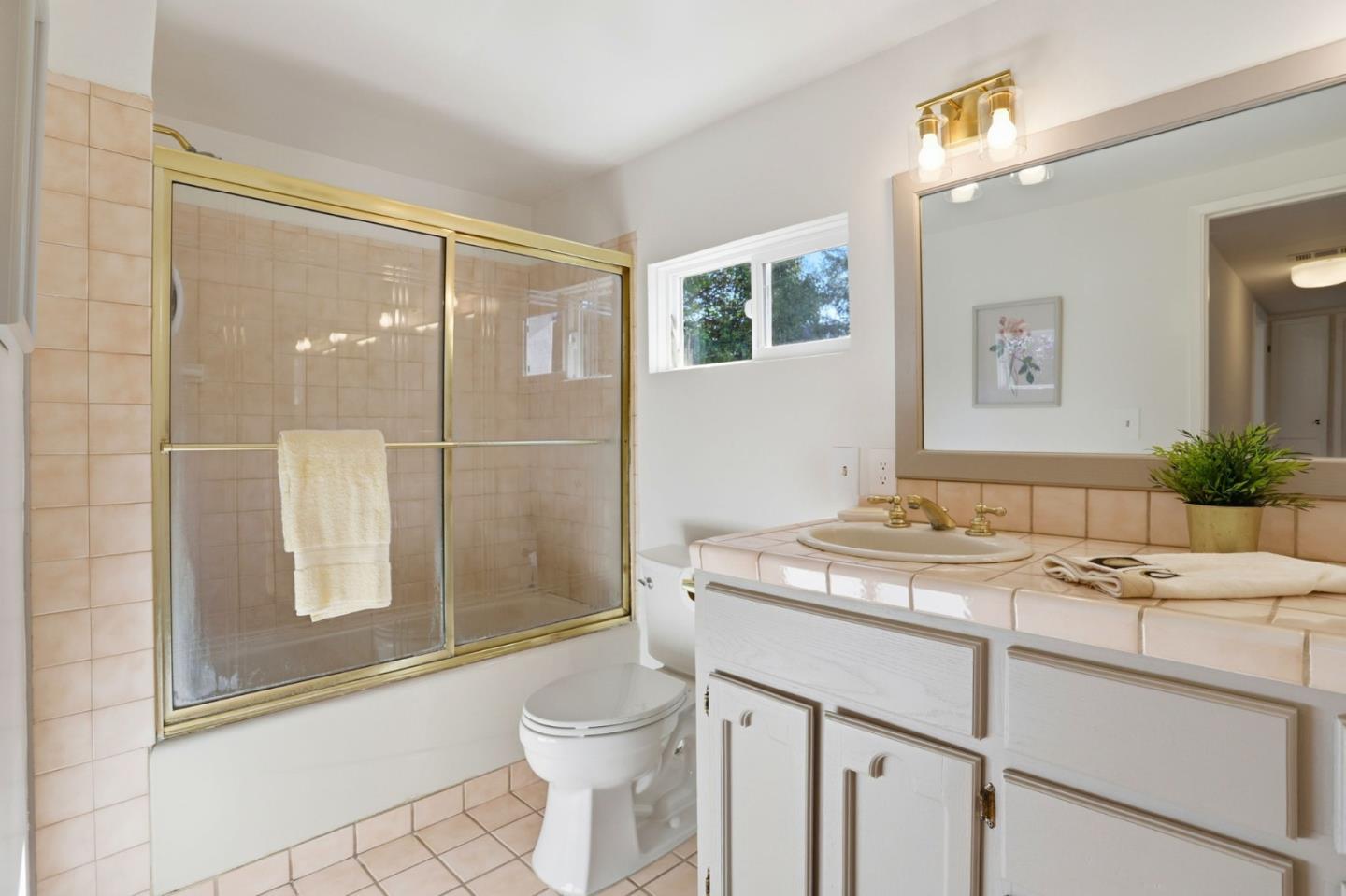 2594 San Juan Road Aromas, CA 95004 - Photo 22 of 34 a bathroom with a granite countertop sink toilet and shower