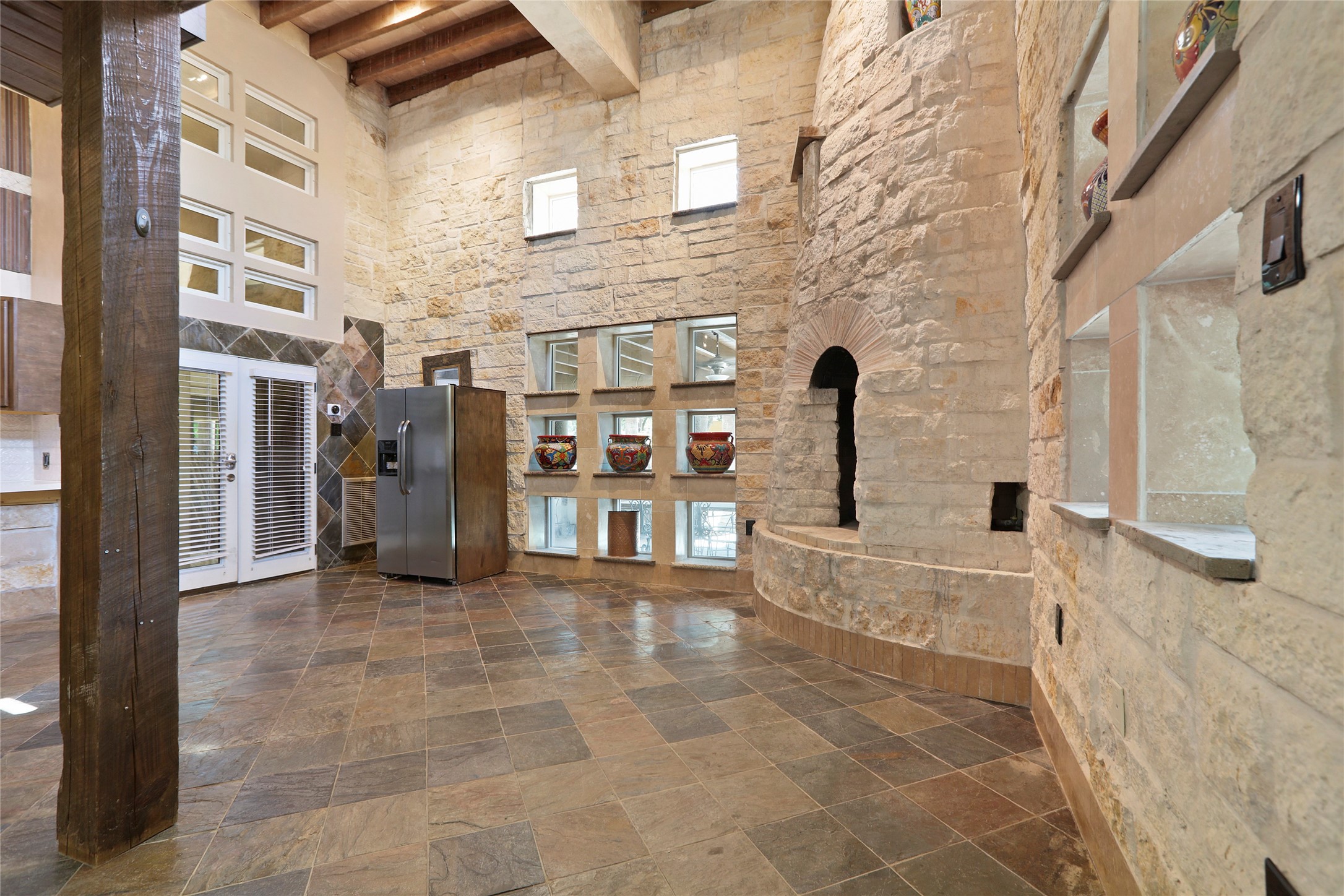 614 Pine Gully Road, Unit LOFT Seabrook, TX 77586 - Photo 4 of 29 Austin stone walls. Double doors to the exterior hallway. Working fireplace with gas starter.