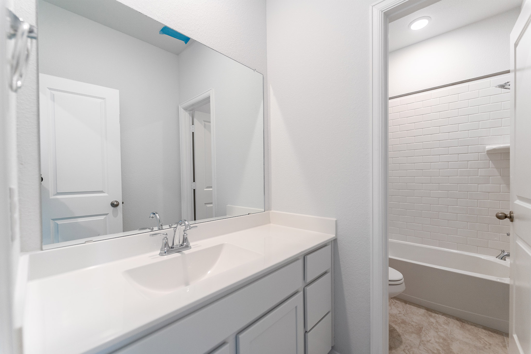 161 Mango Circle Buda, TX 78610 - Photo 14 of 22 a bathroom with a sink and a mirror