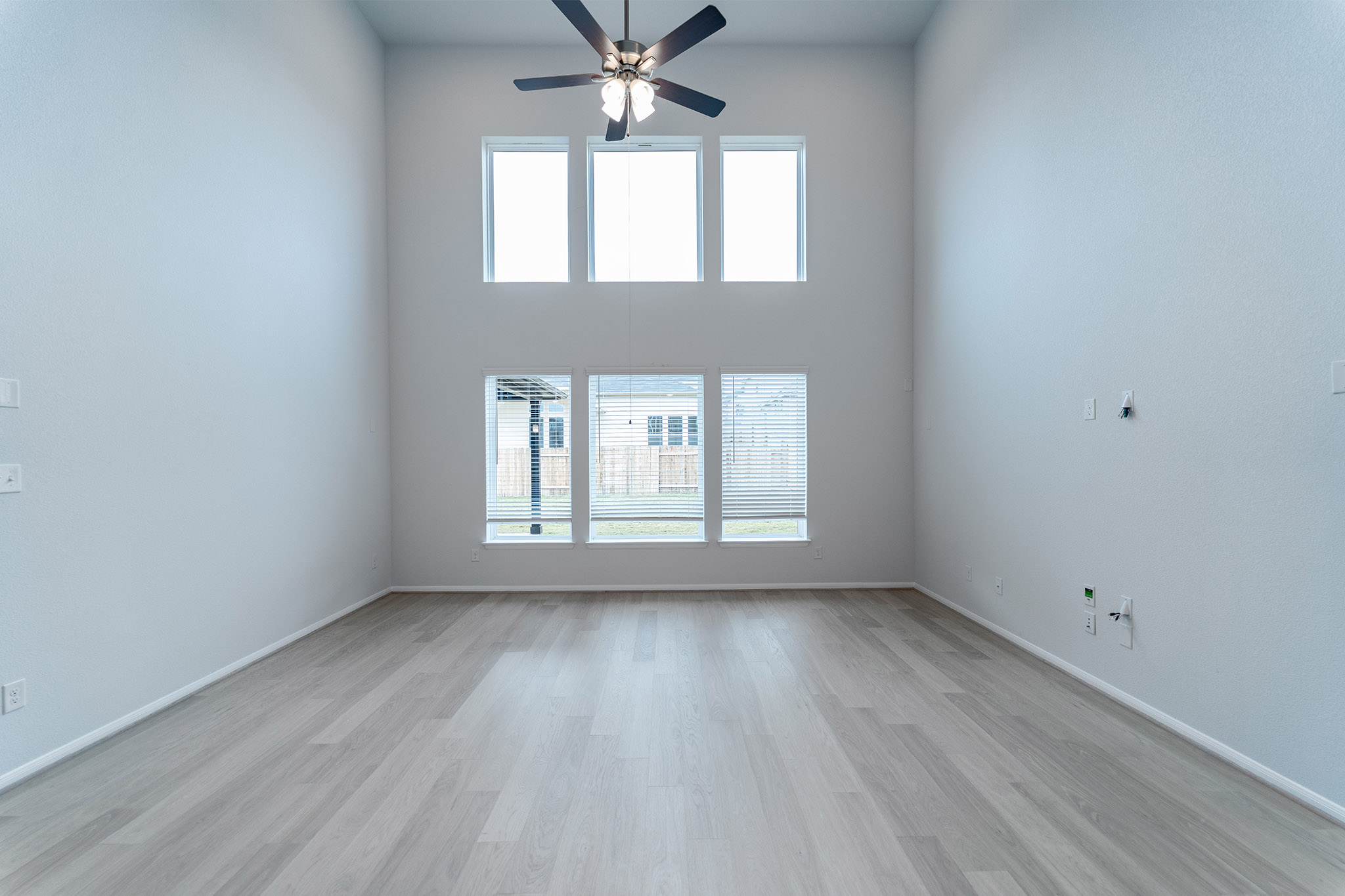161 Mango Circle Buda, TX 78610 - Photo 18 of 22 a view of an empty room with wooden floor and a window