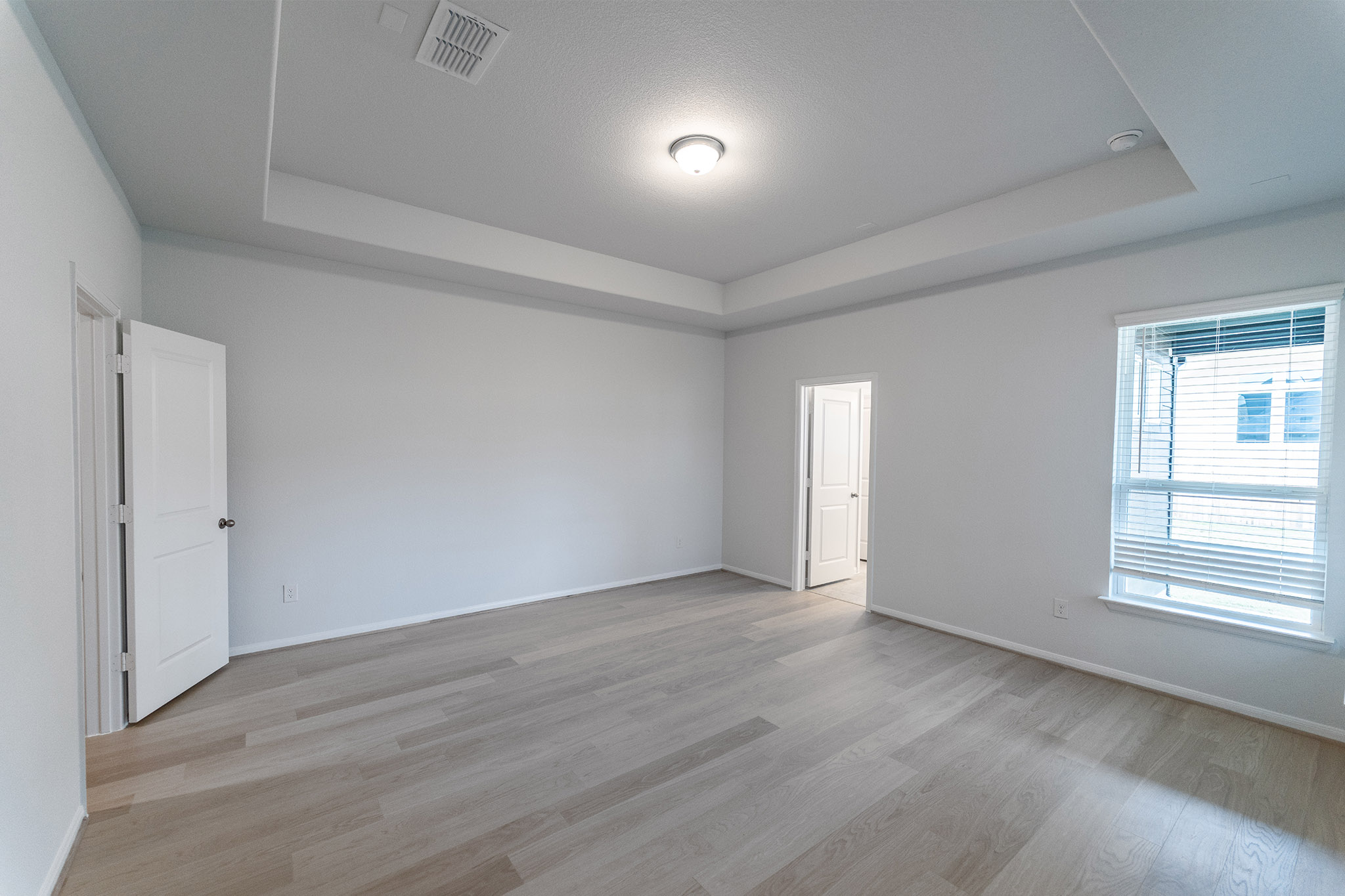 161 Mango Circle Buda, TX 78610 - Photo 19 of 22 an empty room with wooden floor and windows