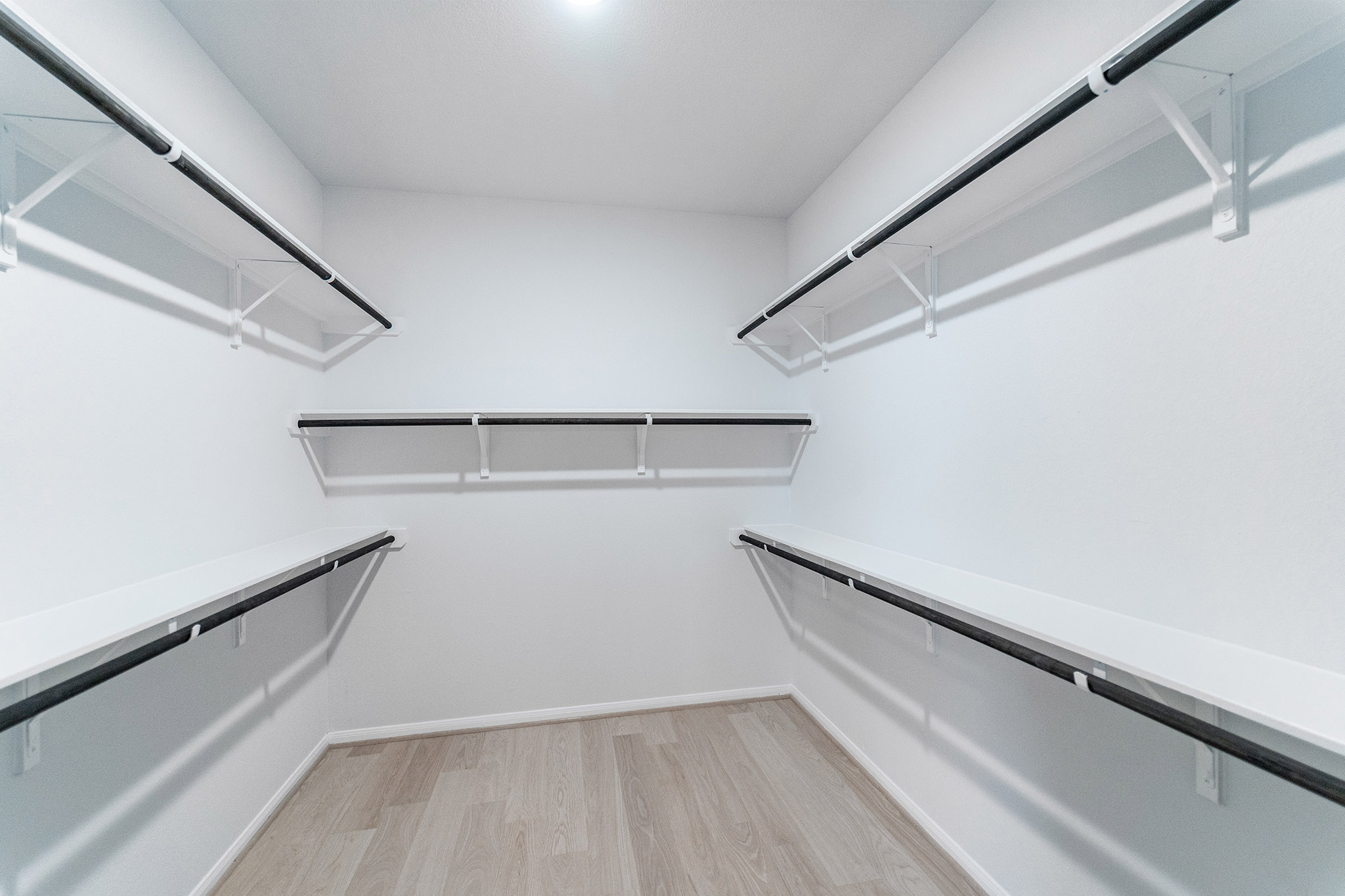 161 Mango Circle Buda, TX 78610 - Photo 20 of 22 a view of a room with racks on the wall