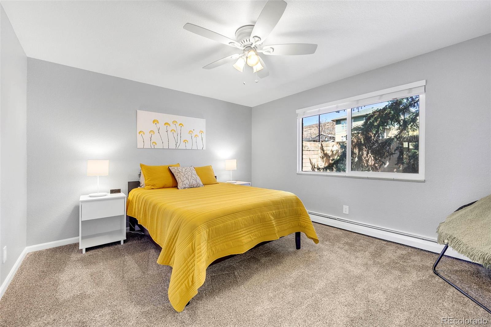 809 5th Street, Unit 201 Golden, CO 80403 - Photo 12 of 32 a spacious bedroom with a bed and a chandelier