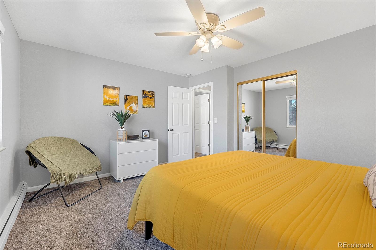 809 5th Street, Unit 201 Golden, CO 80403 - Photo 13 of 32 a bedroom with a bed and a chair
