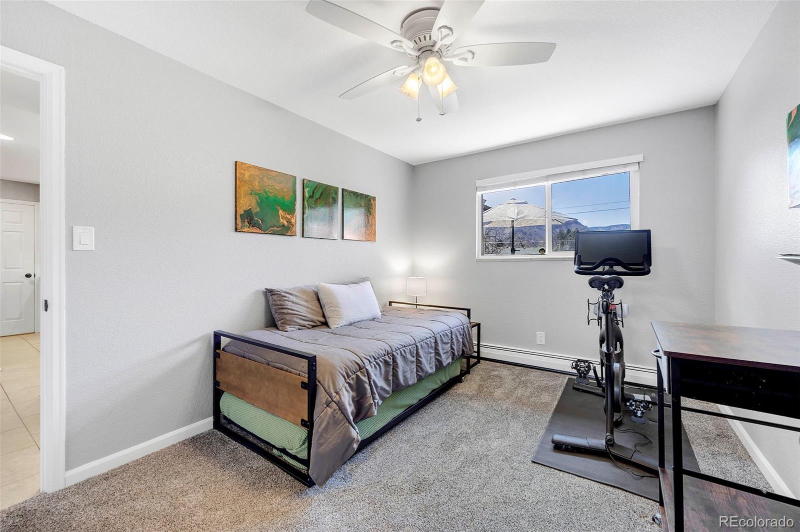 809 5th Street, Unit 201 Golden, CO 80403 - Photo 15 of 32 a bedroom with a bed and a chandelier