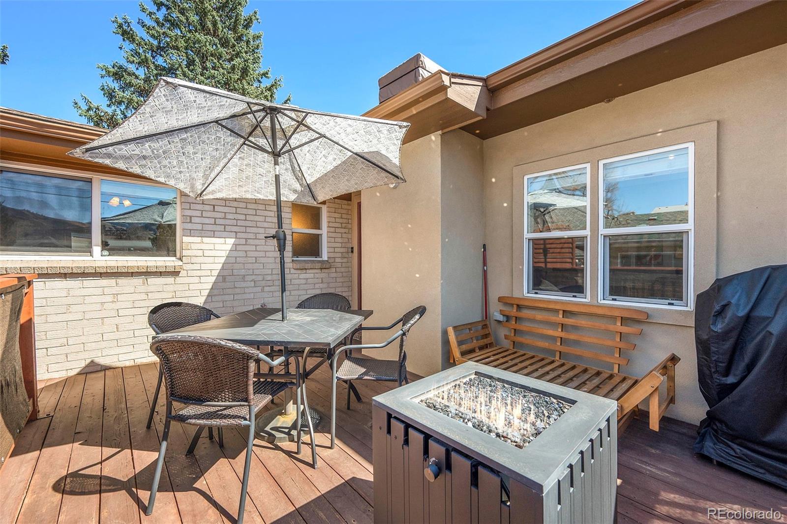 809 5th Street, Unit 201 Golden, CO 80403 - Photo 17 of 32 a view of a patio with table and chairs with wooden floor and fence
