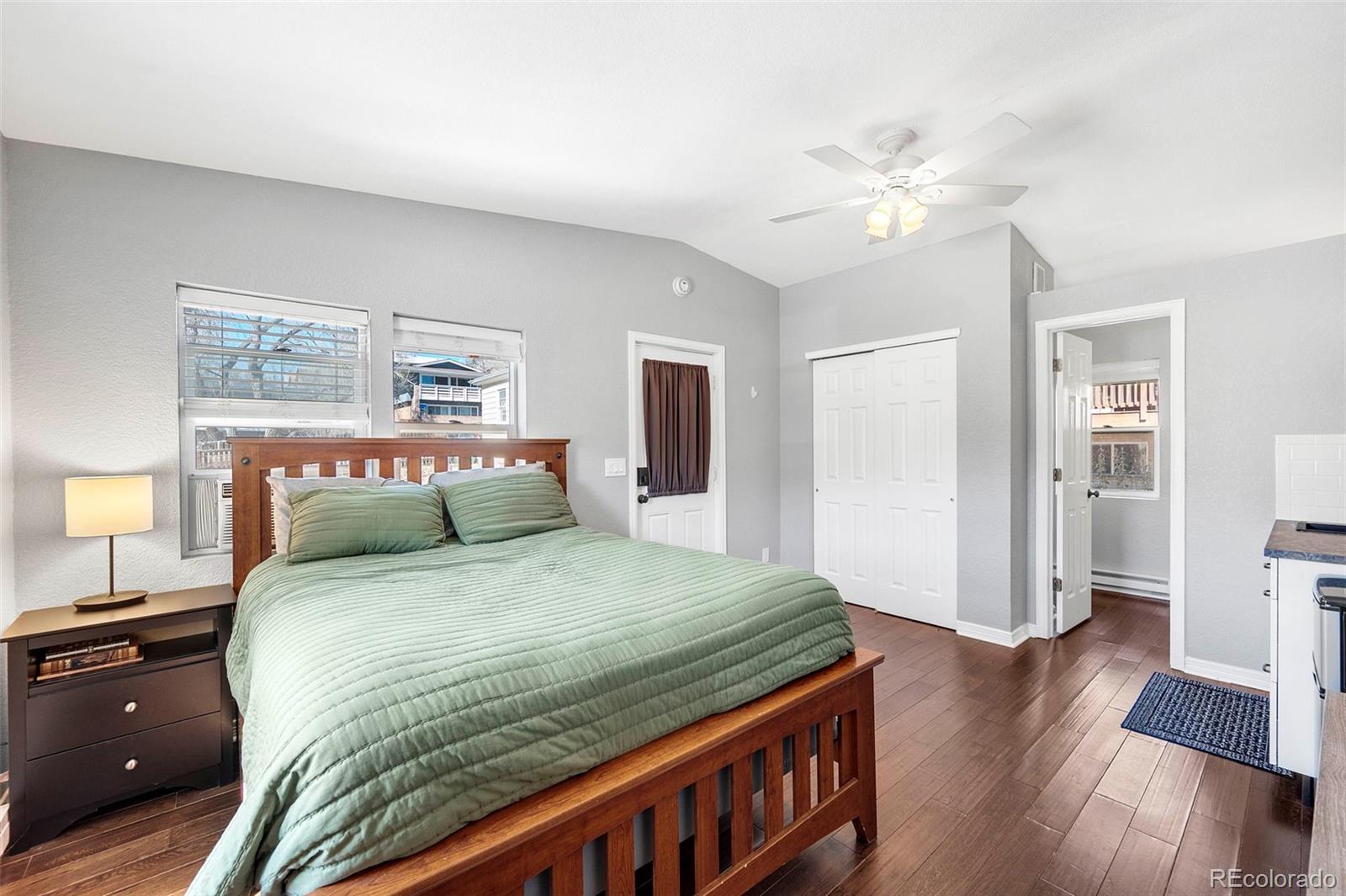 809 5th Street, Unit 201 Golden, CO 80403 - Photo 20 of 32 a bedroom with a bed and wooden floor