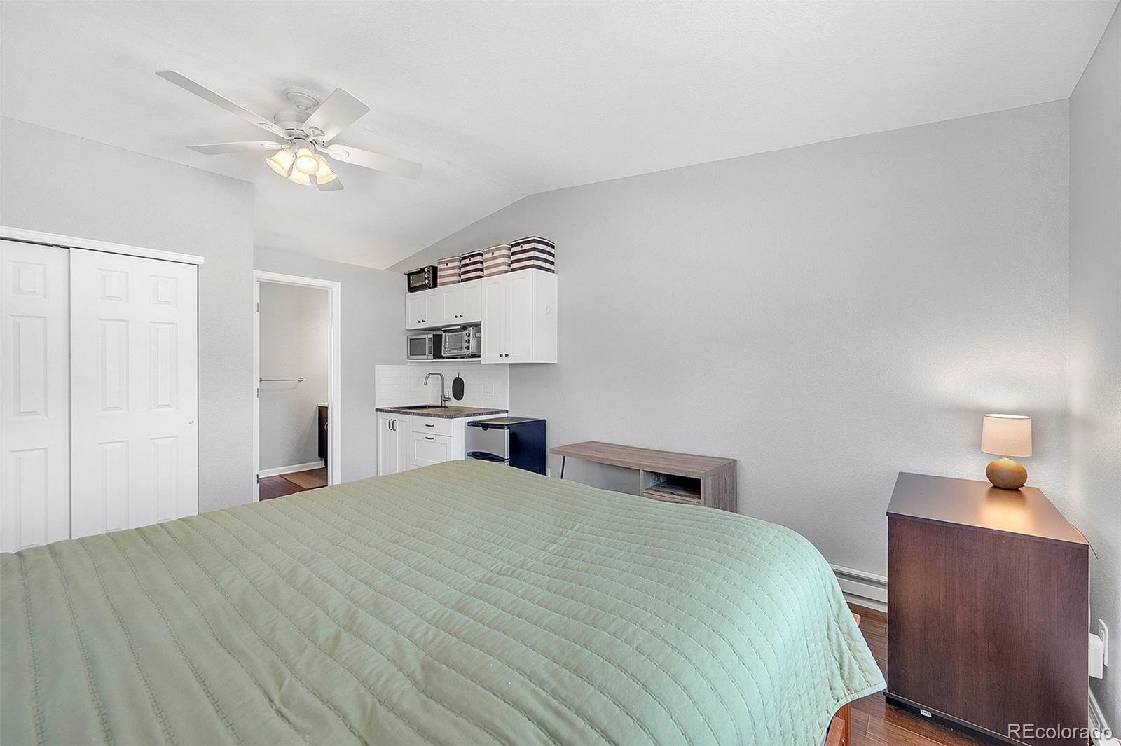 809 5th Street, Unit 201 Golden, CO 80403 - Photo 21 of 32 a bedroom with a bed and a chandelier