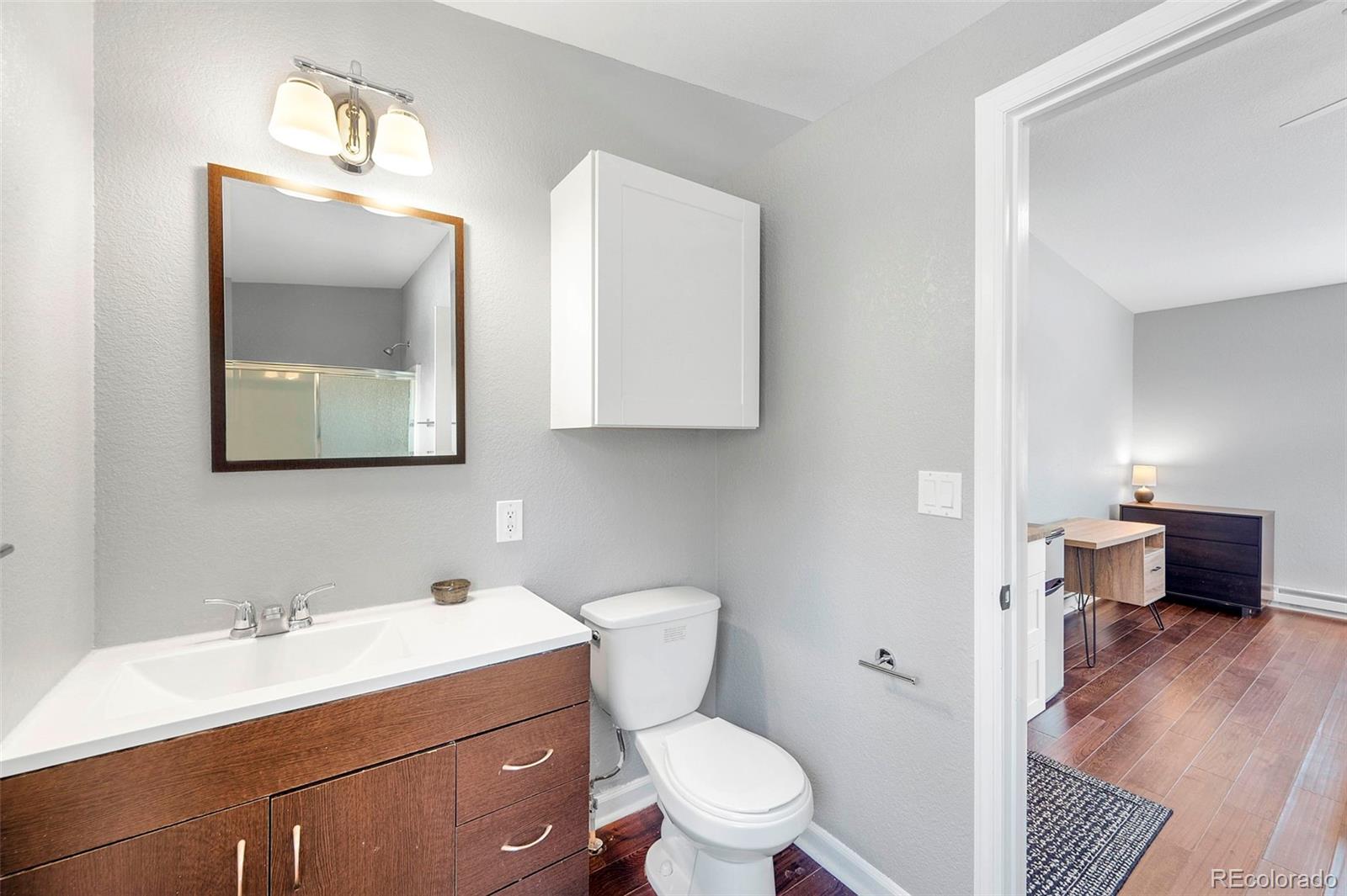 809 5th Street, Unit 201 Golden, CO 80403 - Photo 23 of 32 a bathroom with a toilet a sink and mirror