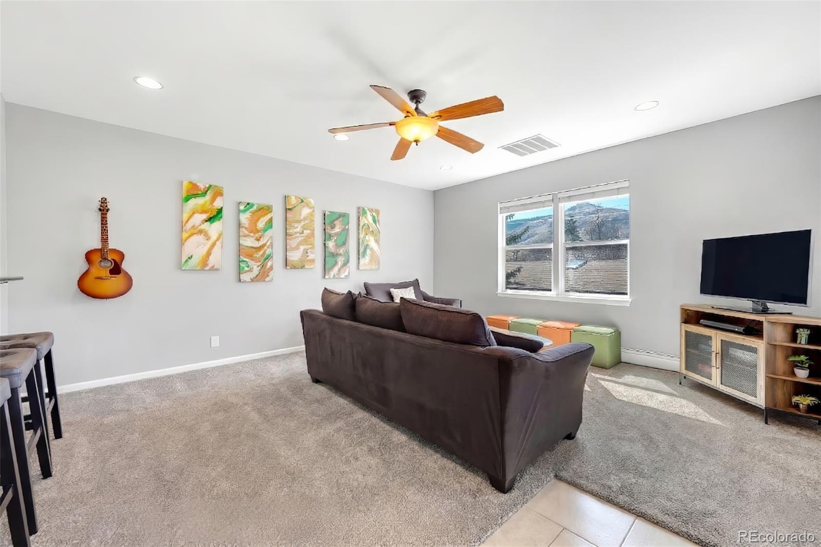 809 5th Street, Unit 201 Golden, CO 80403 - Photo 4 of 32 a living room with furniture and a flat screen tv