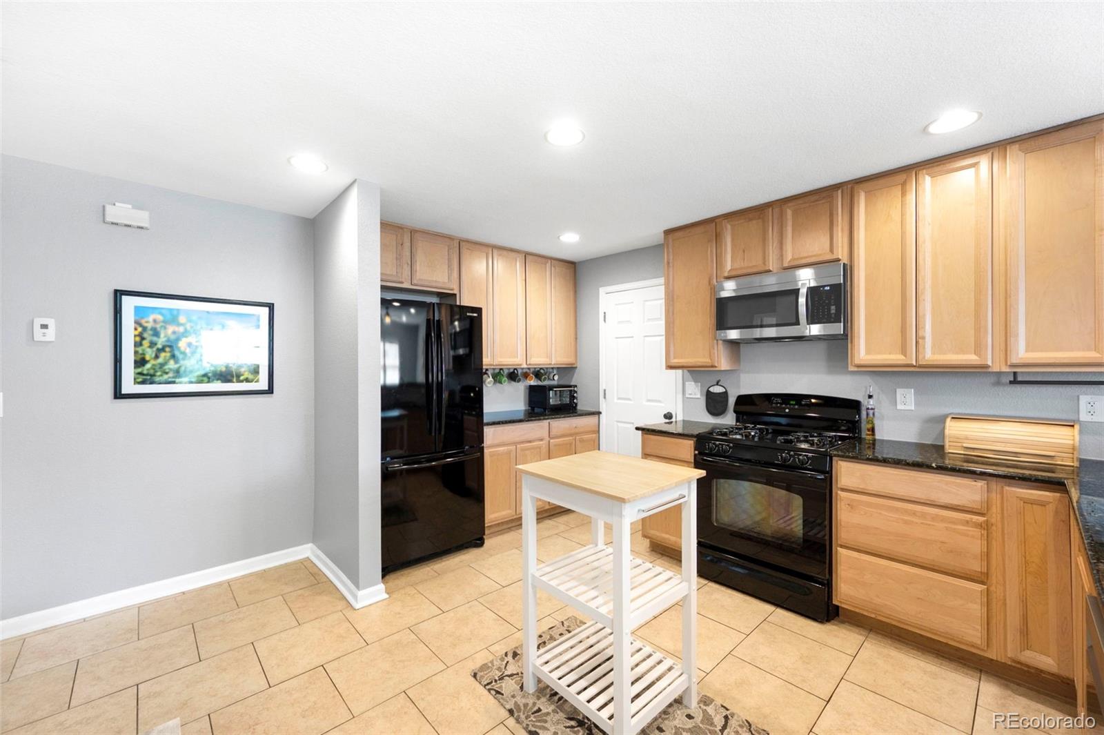 809 5th Street, Unit 201 Golden, CO 80403 - Photo 8 of 32 a kitchen with stainless steel appliances granite countertop a refrigerator stove top oven and sink