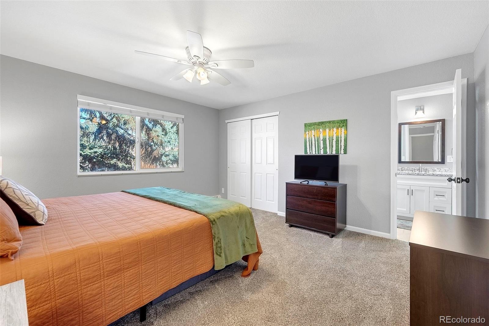 809 5th Street, Unit 201 Golden, CO 80403 - Photo 10 of 32 a bedroom with a bed and a chandelier