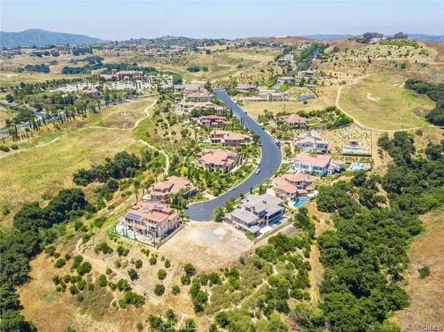 an aerial view of lake and residential houses with outdoor space