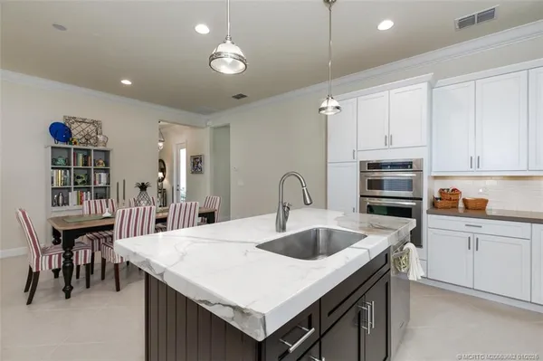 a kitchen that has a table and chairs in it