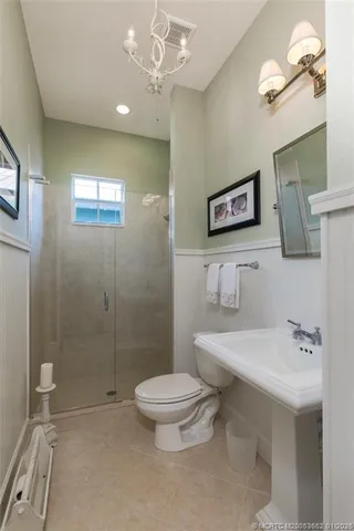 a bathroom with a toilet sink and shower