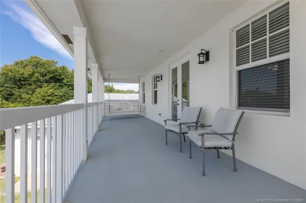 a view of two chairs in the balcony