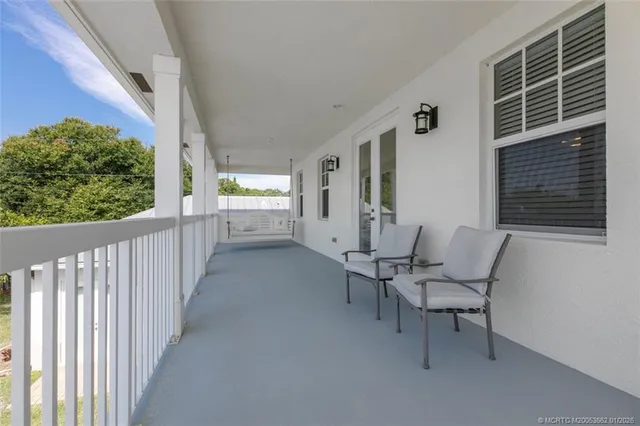 a view of two chairs in the balcony