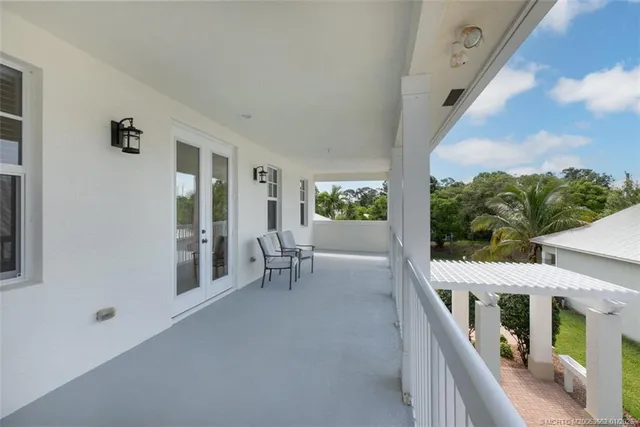 a view of a porch with furniture and a gate