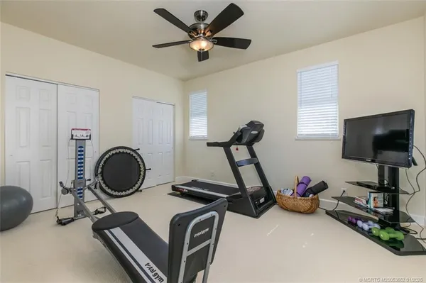 a room with gym equipment and windows