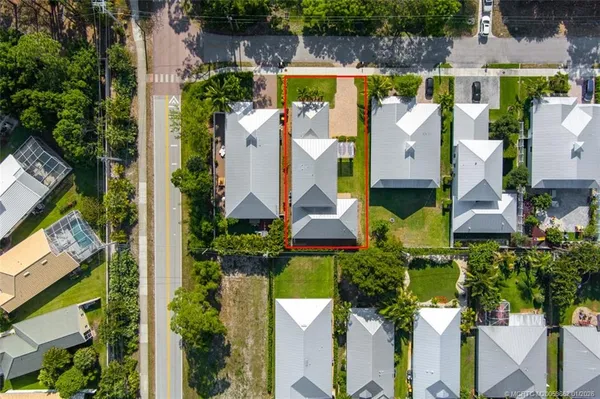 an aerial view of house with a yard and a large pool