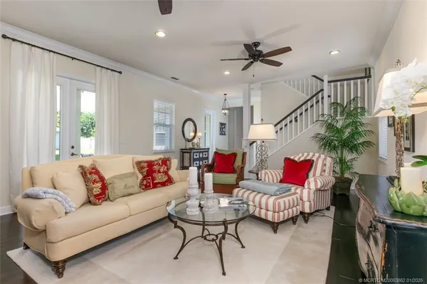 a living room with furniture and a potted plant