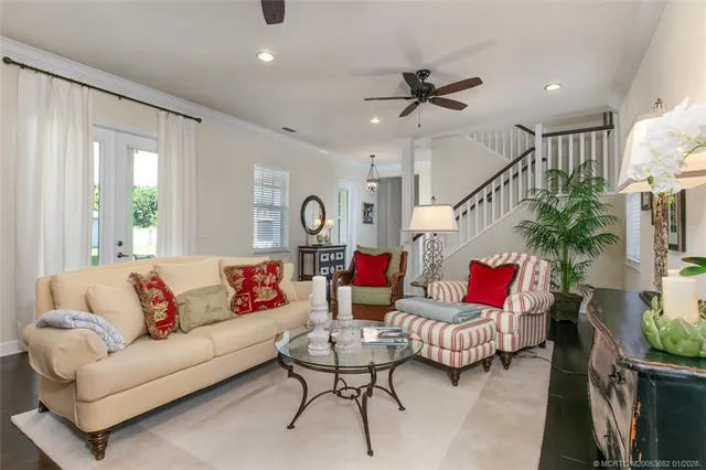 a living room with furniture and a potted plant