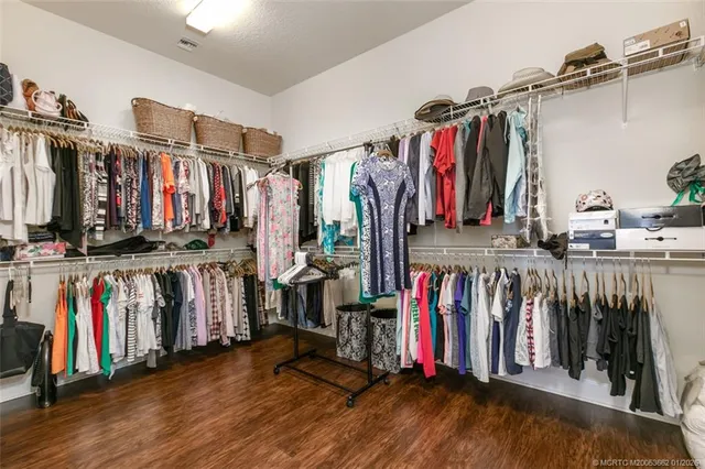 a view of walk in closet with clothes