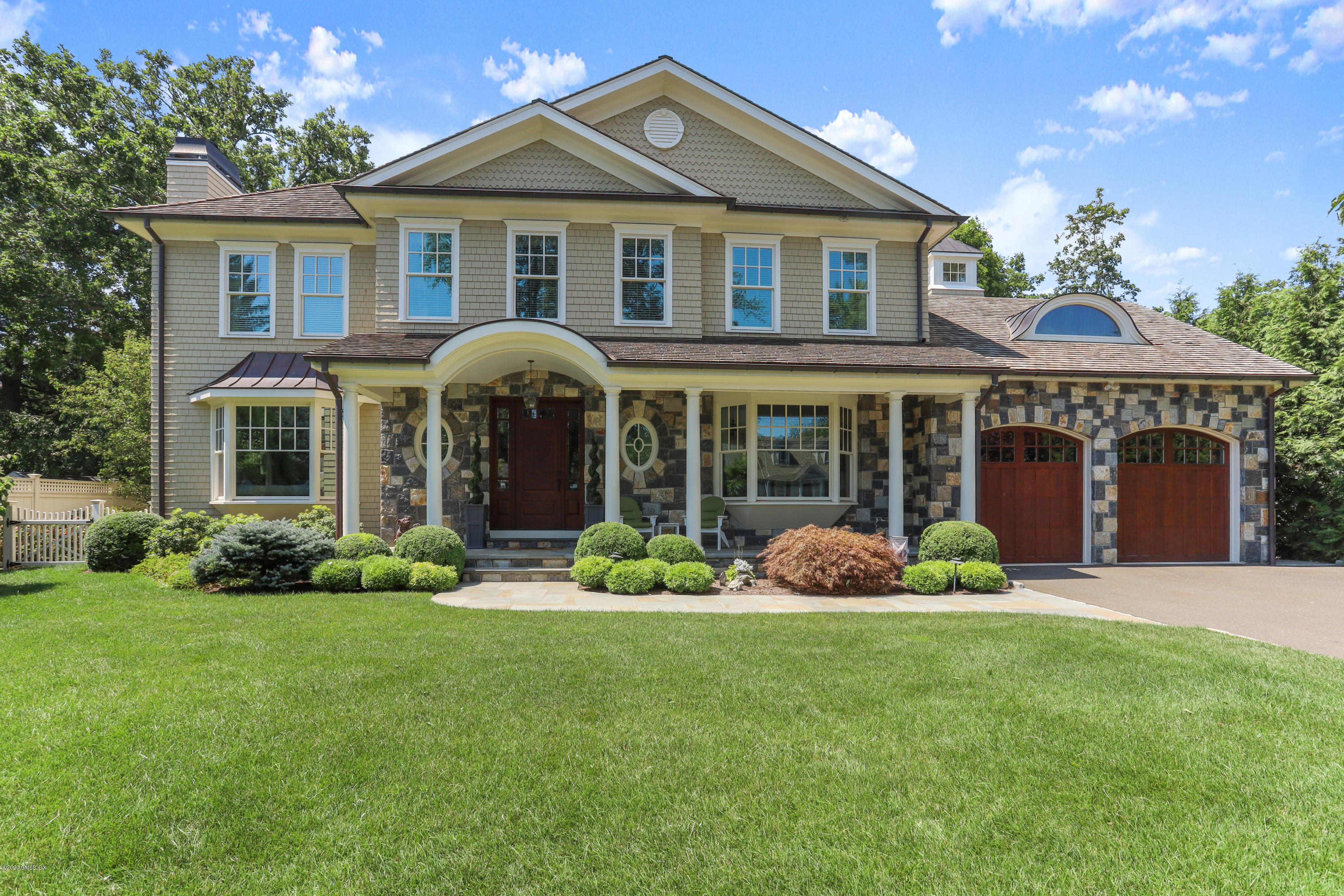 16 Center Road Old Greenwich, CT 06870 - Photo 1 of 35 a front view of a house with a garden and porch