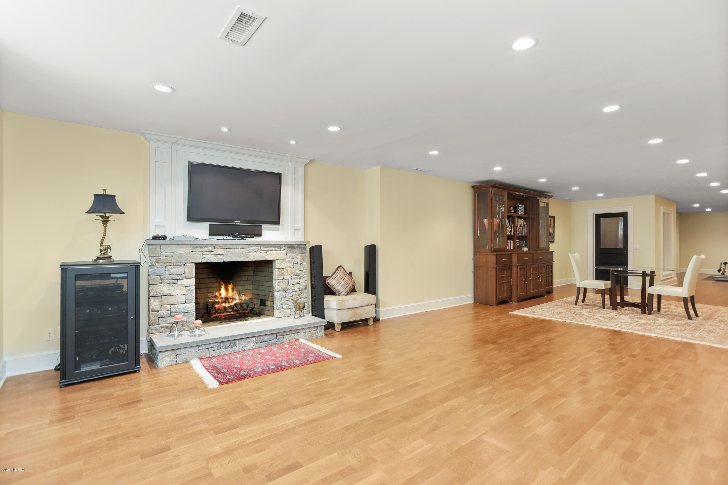 16 Center Road Old Greenwich, CT 06870 - Photo 29 of 35 a living room with furniture a fireplace and a flat screen tv