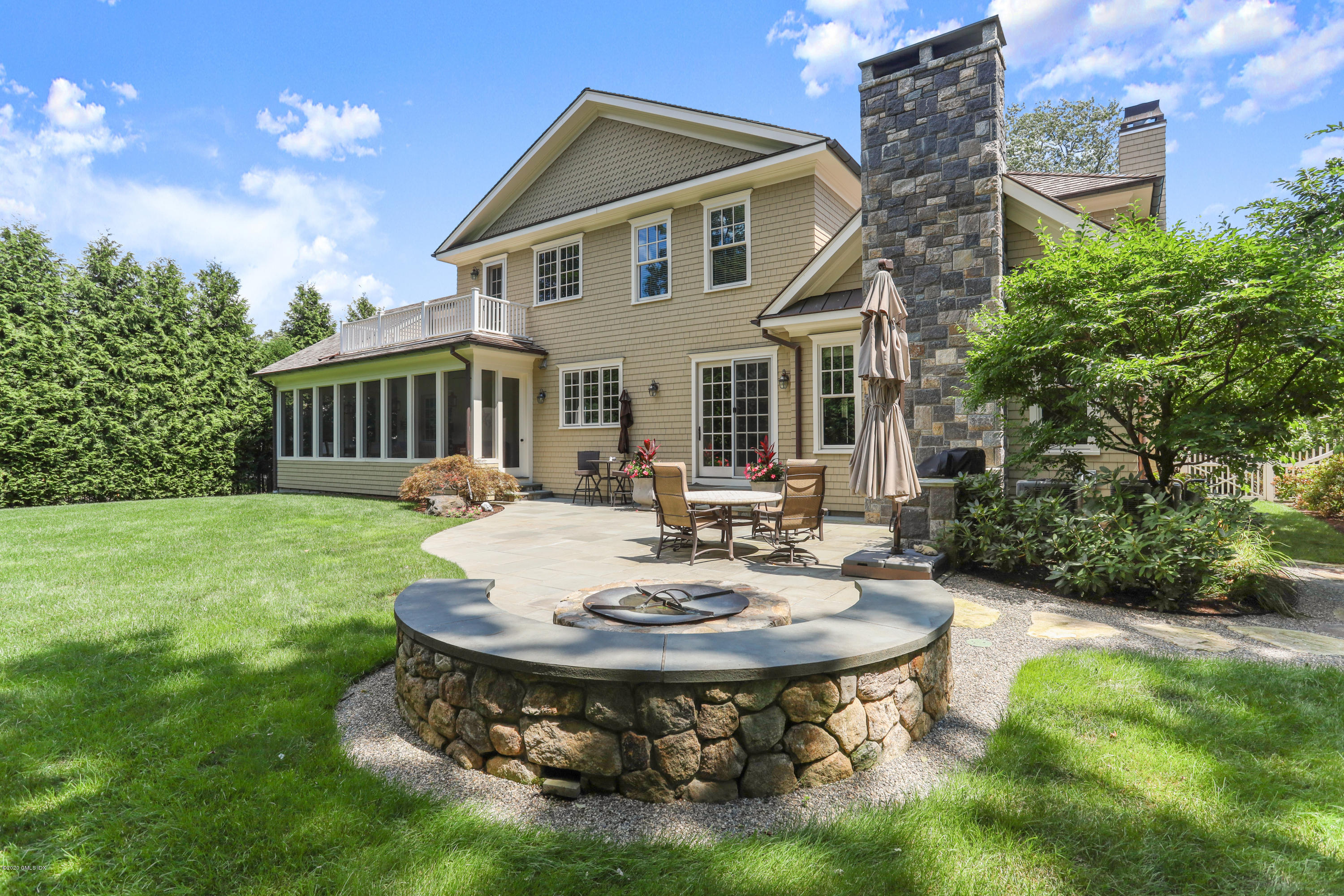16 Center Road Old Greenwich, CT 06870 - Photo 33 of 35 a view of a house with a yard patio and fire pit