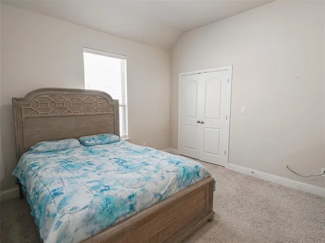 a bedroom with a bed and window
