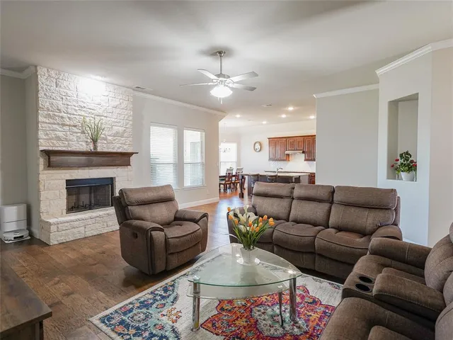 a living room with furniture a fireplace and a flat screen tv