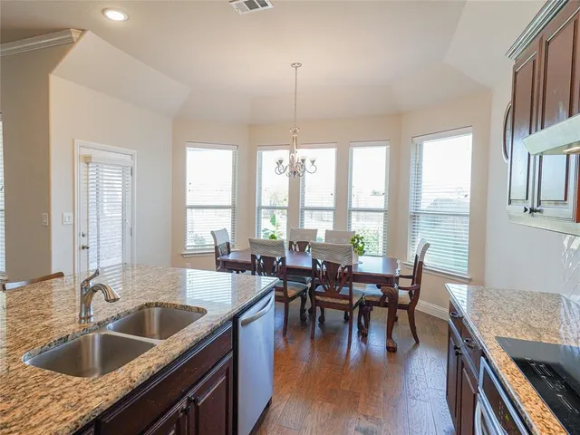 a kitchen with a table chairs stove and couches