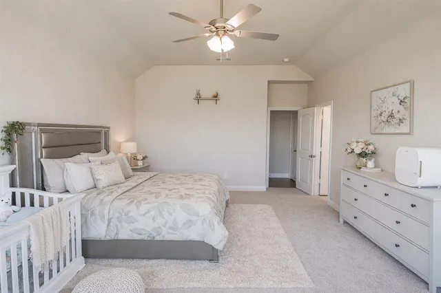 a bedroom with a large bed and a chandelier