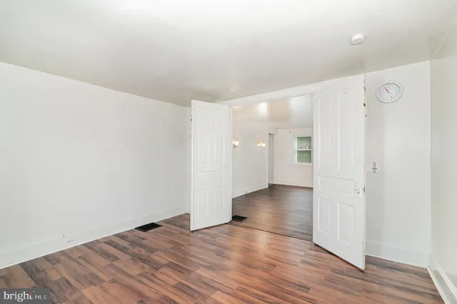 a view of an empty room and wooden floor