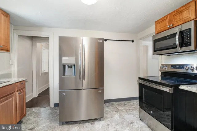 a metallic refrigerator freezer sitting in a kitchen