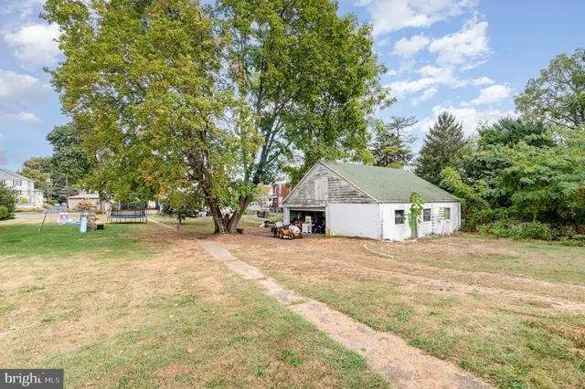 a view of a white house with a yard