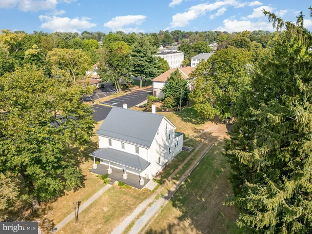 a house that has a tree in front of it