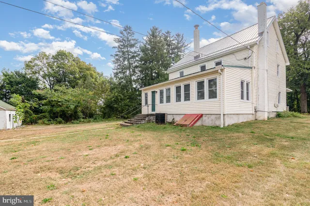 a aerial view of a house with a yard and a garden
