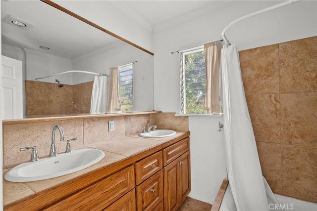 a bathroom with a granite countertop sink and a large mirror