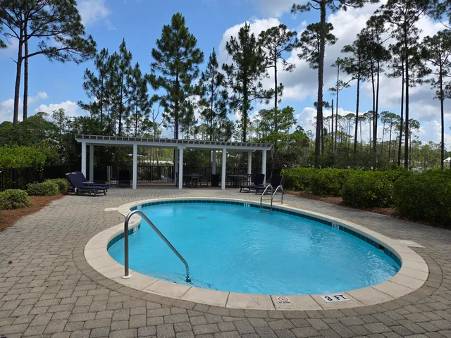 a view of a swimming pool with outdoor seating and lake