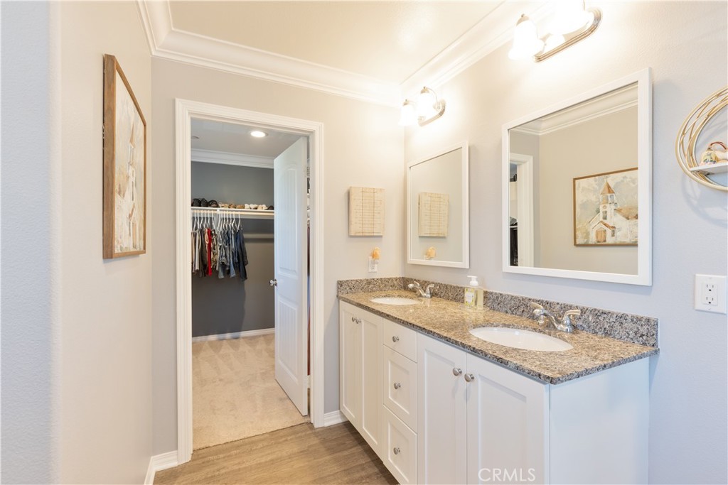 30283 Ramsay Drive Menifee, CA 92584 - Photo 14 of 24 a bathroom with a granite countertop sink and a mirror